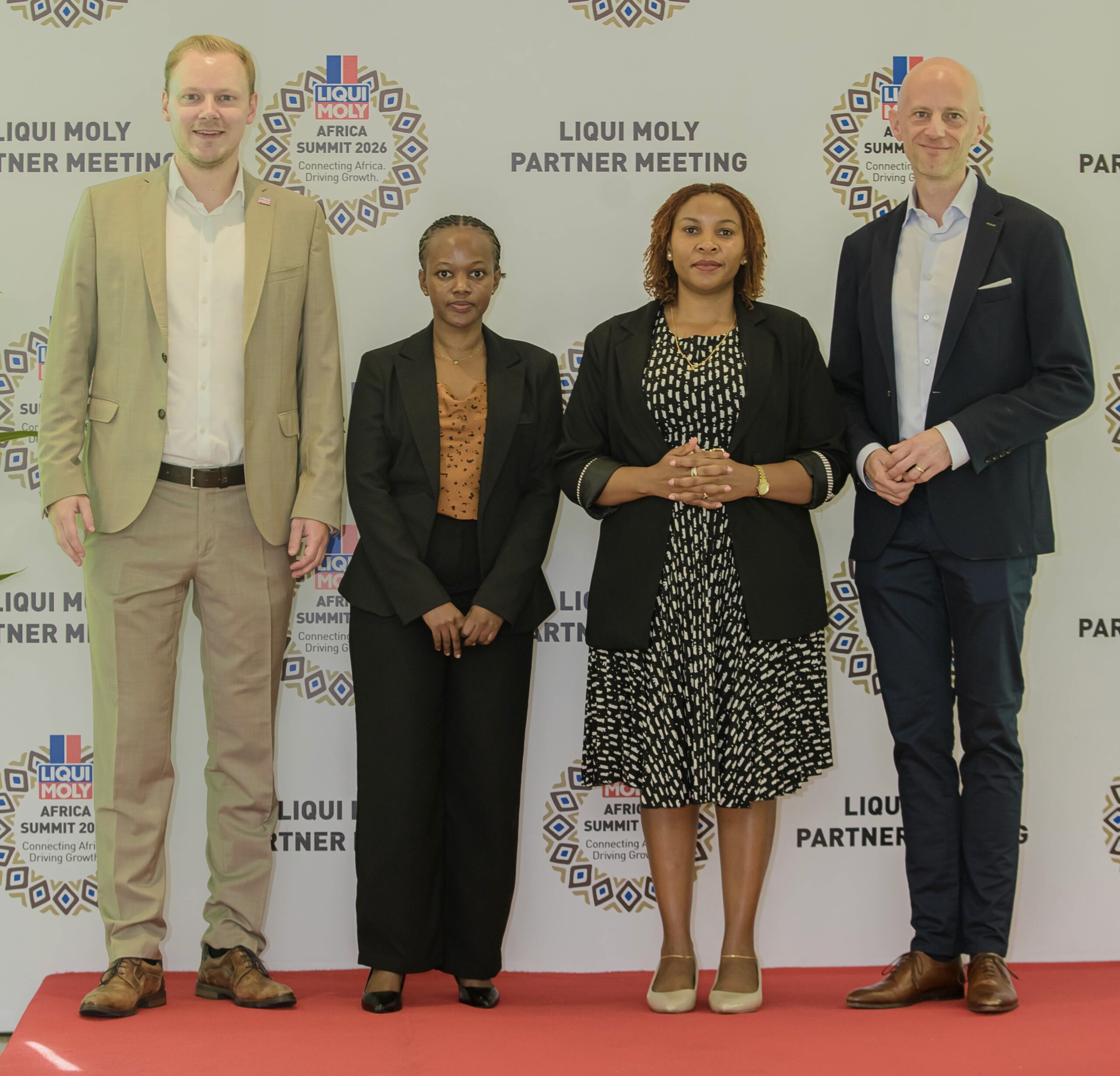Marco Renz of Liqui Moly with the africon team, Sweetness Mathew, Aneth Herman and Marc Zander, in front of the Liqui Moly Africa Summit 2026 backdrop in Dar es Salaam